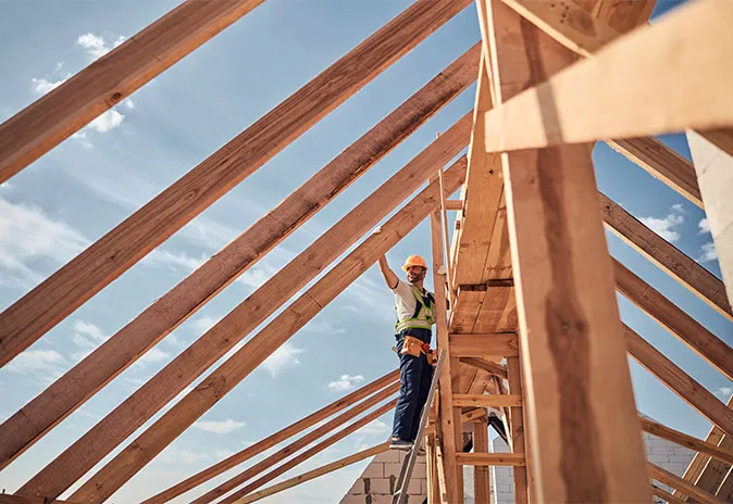 Builder working on a building roof structure