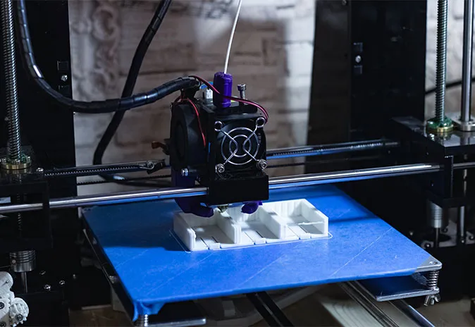 3d printer printing a house model